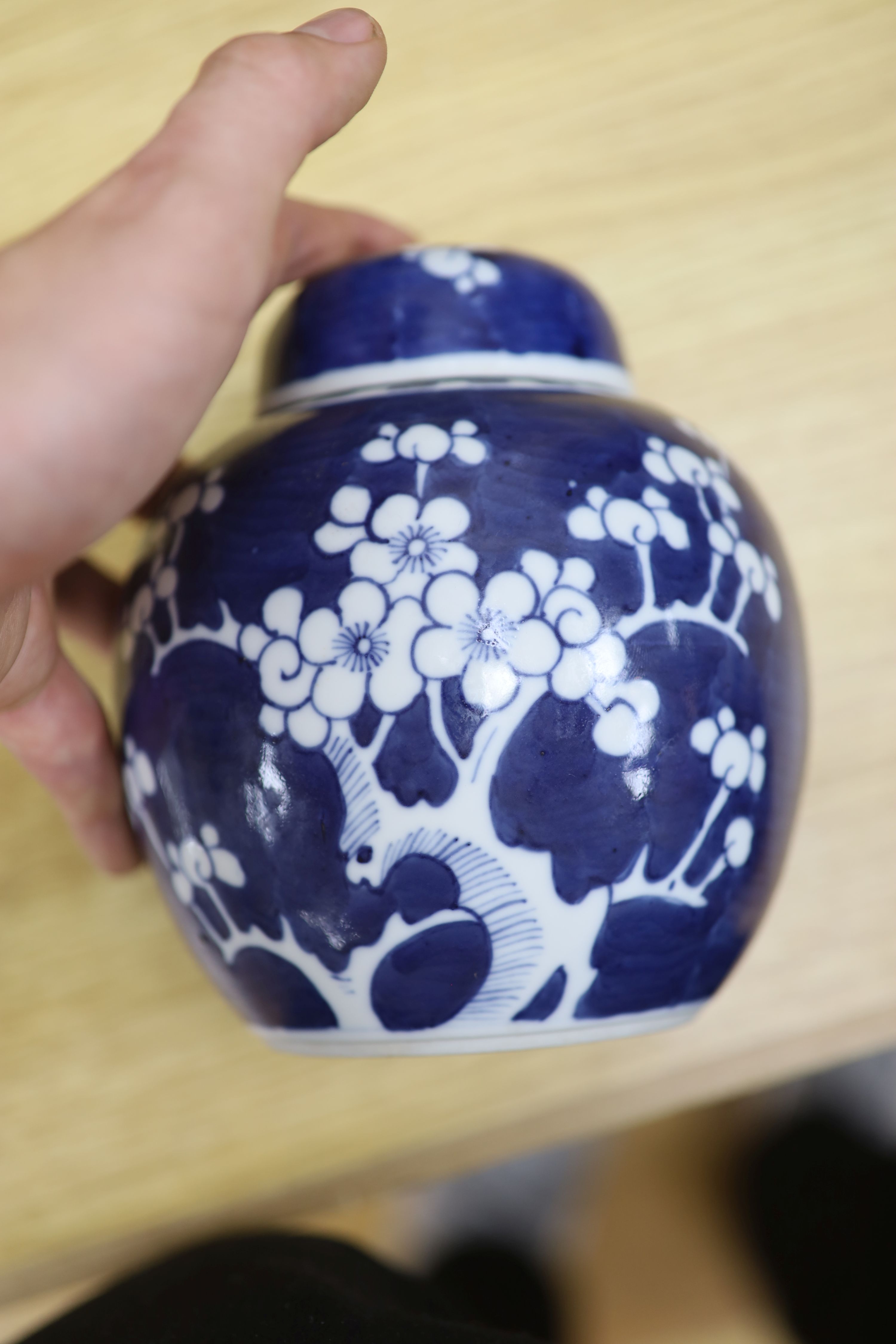 Two Chinese blue and white prunus pattern ginger jars and a similar cylinder vase, tallest 26cm